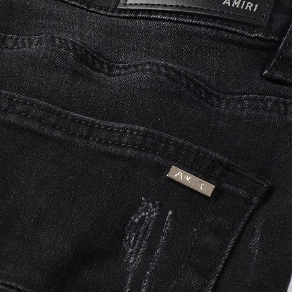 AMIRI Patchwork Slim Jeans – Full Logo Distressed Denim