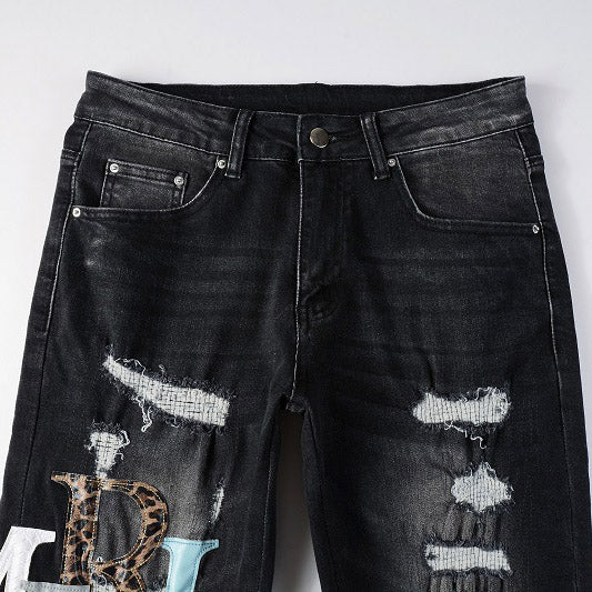 AMIRI Patchwork Slim Jeans – Full Logo Distressed Denim