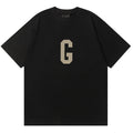 Fear of God Flocked G Letter Pattern T-Shirt – Black / Light Grey / Apricot